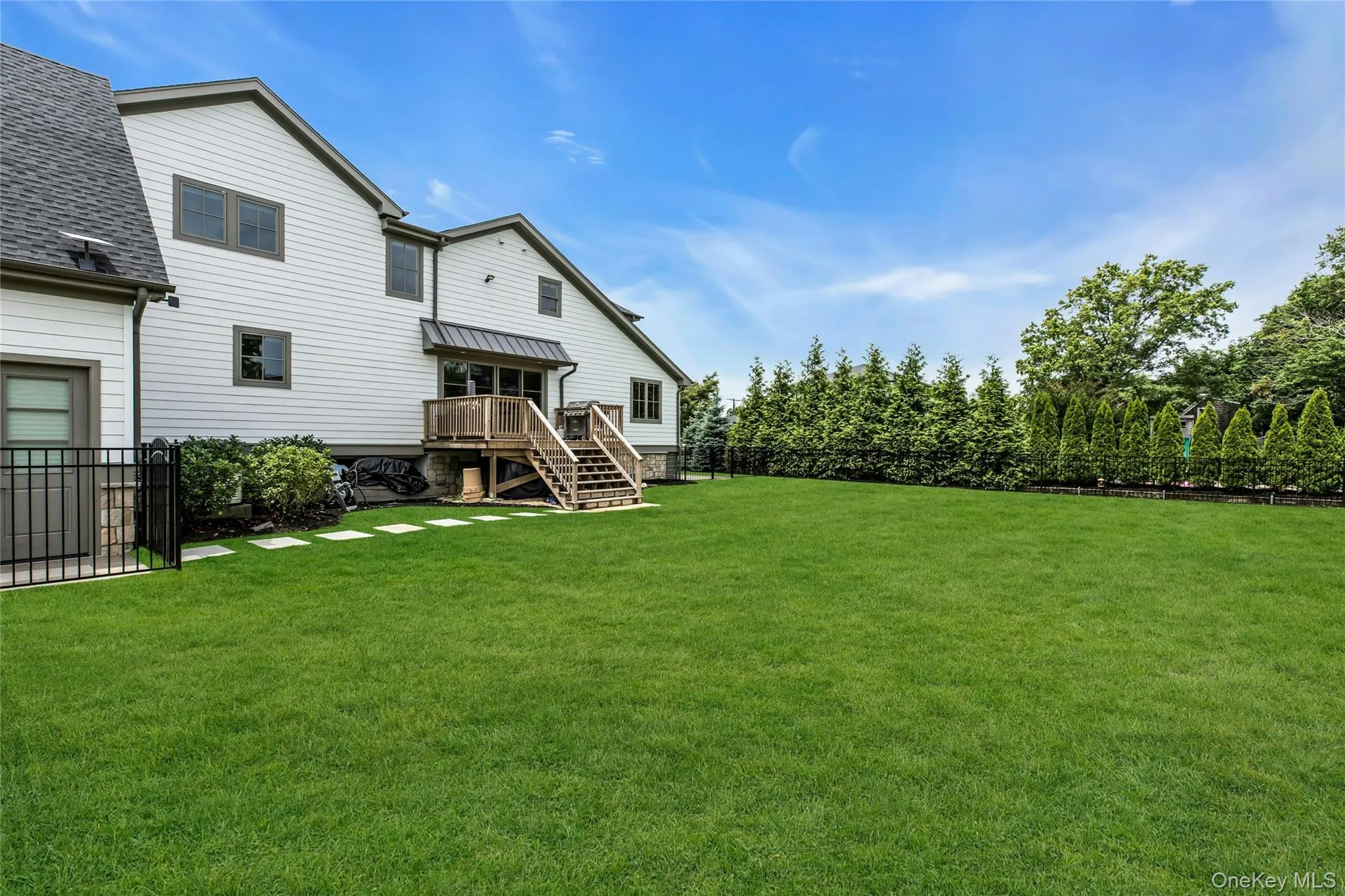 Fenced backyard with stairs and a deck Fenced backyard with stairs and a deck
