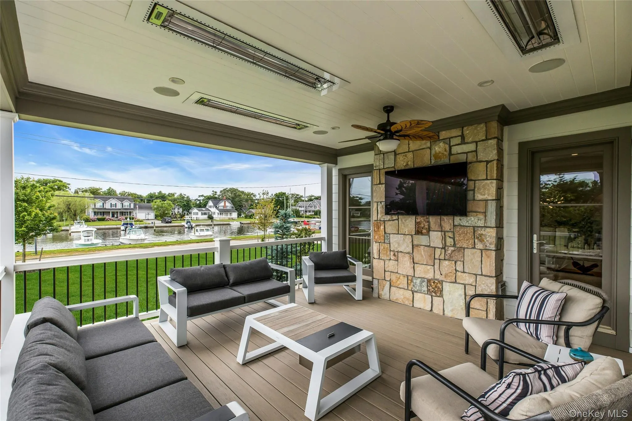 Deck featuring an outdoor living space, a ceiling fan, and a lawn Deck featuring an outdoor living space, a ceiling fan, and a lawn