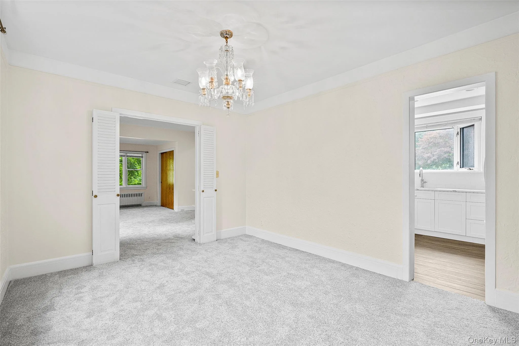 Carpeted dining with a classic chandelier Carpeted dining with a classic chandelier