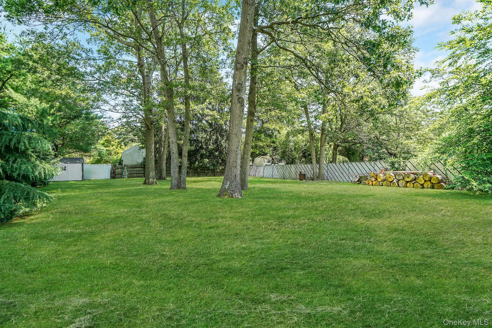 Fenced backyard featuring a storage shed Fenced backyard featuring a storage shed