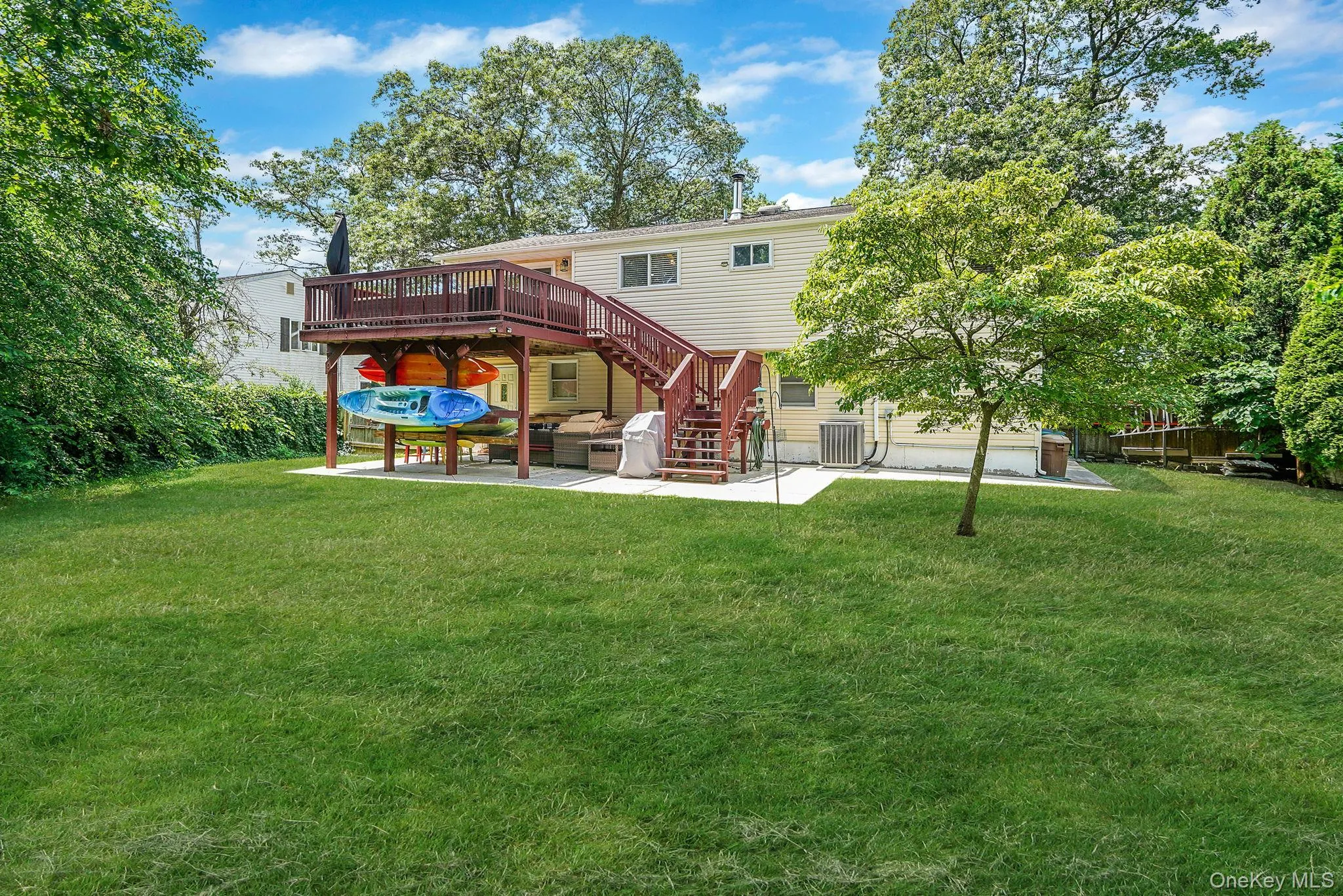 Back of property with a patio, a deck, and stairway Back of property with a patio, a deck, and stairway