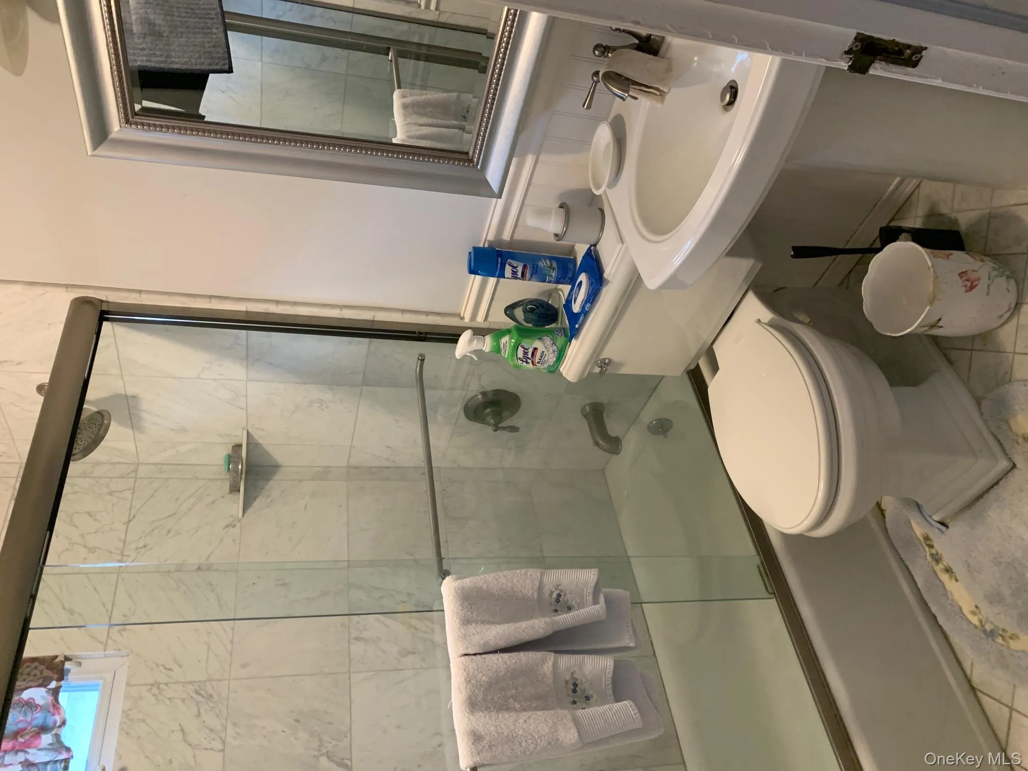 Bathroom with tile patterned flooring, toilet, and combined bath / shower with glass door Bathroom with tile patterned flooring, toilet, and combined bath / shower with glass door