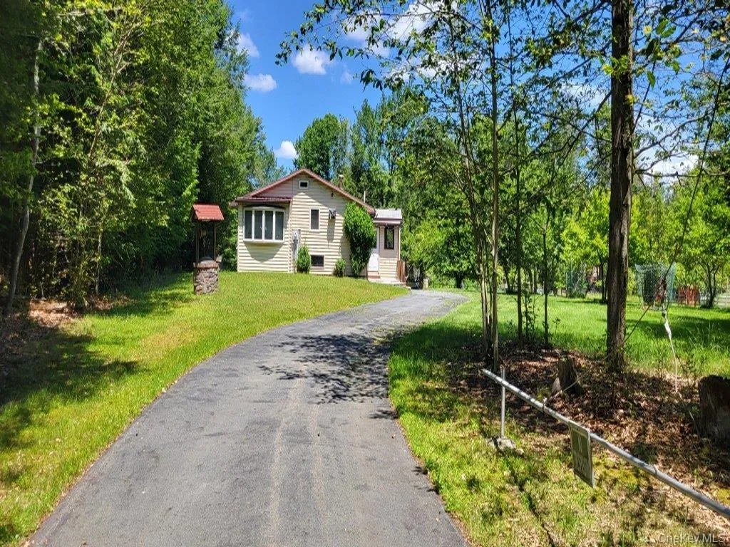 View of front facade with driveway and a front yard View of front facade with driveway and a front yard