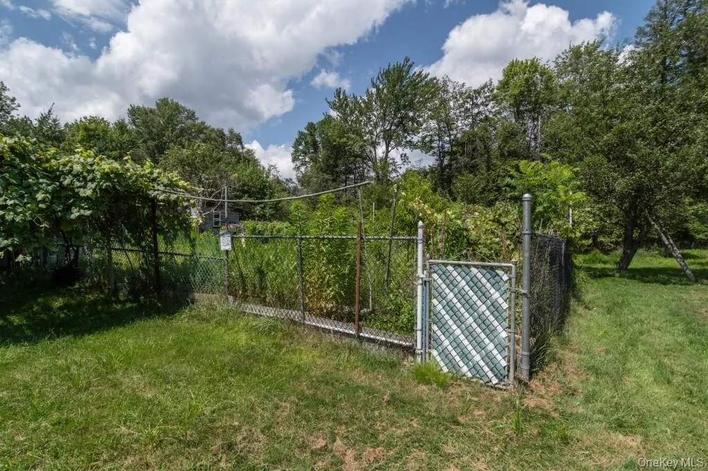 View of yard featuring a gate View of yard featuring a gate