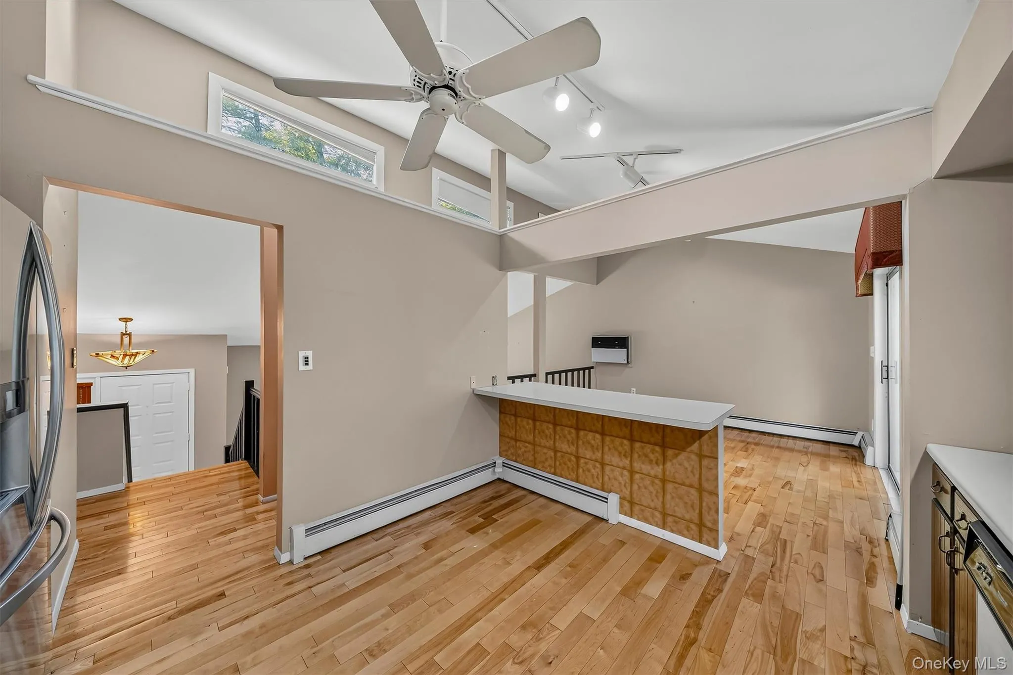 Open space!Wide hall entrance, kitchen naturally flows into the dining area. Note the hardwood floors Open space!Wide hall entrance, kitchen naturally flows into the dining area. Note the hardwood floors