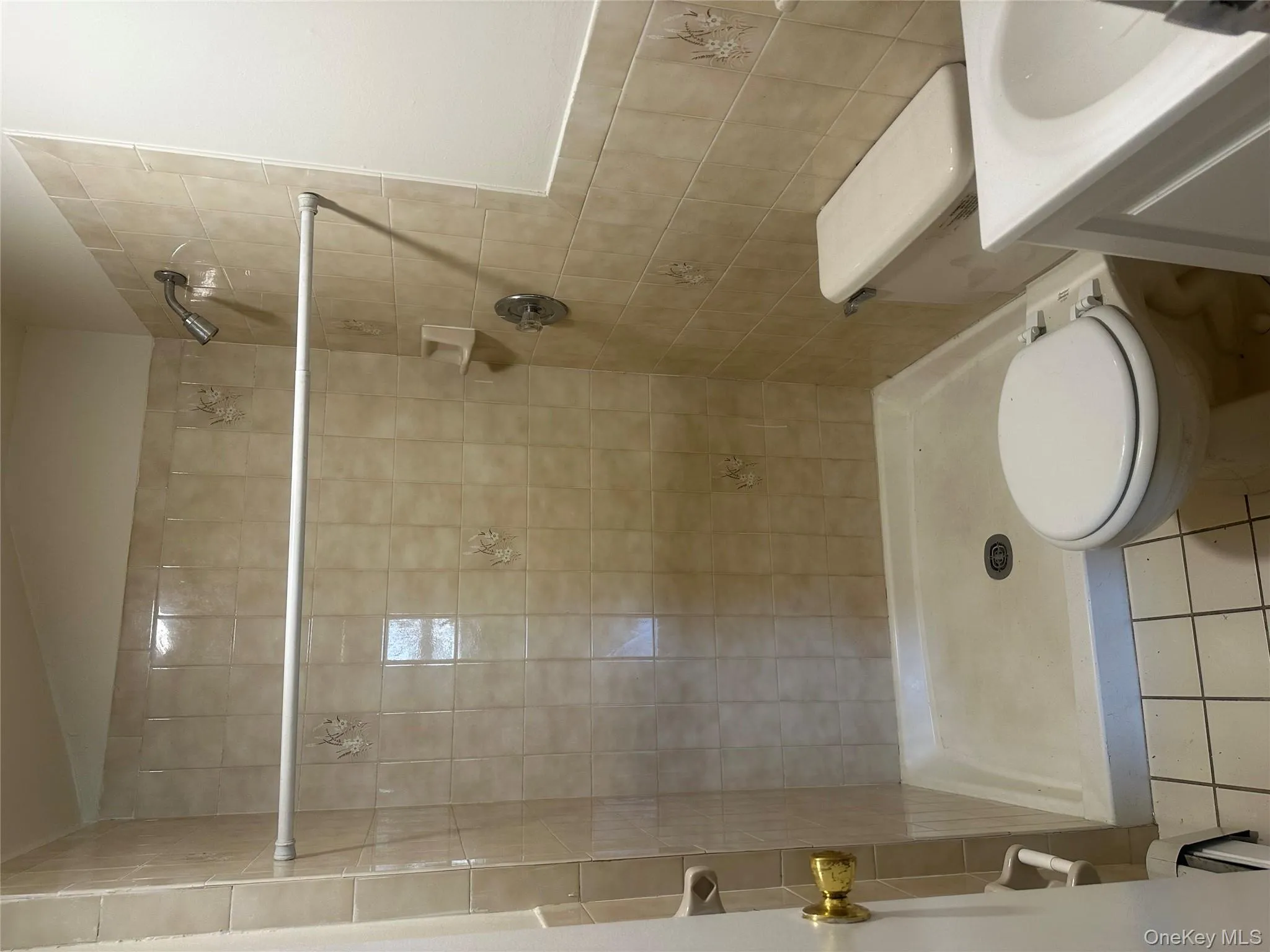 Bathroom featuring a tile shower, tile patterned floors, and vanity Bathroom featuring a tile shower, tile patterned floors, and vanity