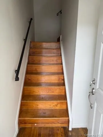 Stairway with hardwood / wood-style flooring and baseboards Stairway with hardwood / wood-style flooring and baseboards