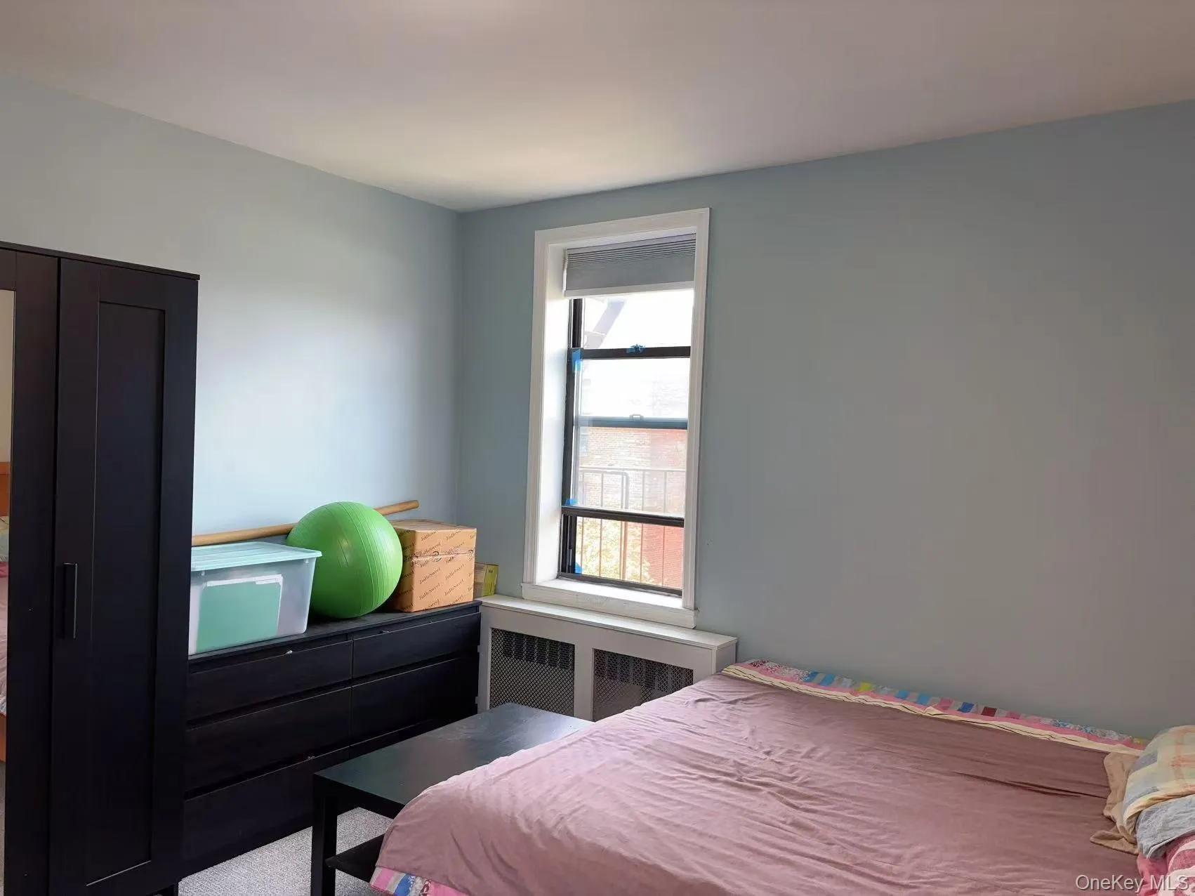 Bedroom with radiator heating unit Bedroom with radiator heating unit