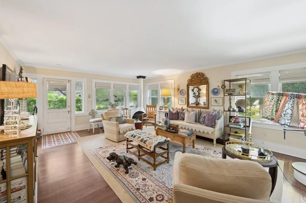 Living room featuring wood finished floors and crown molding Living room featuring wood finished floors and crown molding