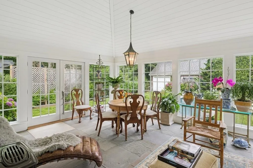 4 seasons Sunroom with healthy amount of natural light and french doors 4 seasons Sunroom with healthy amount of natural light and french doors