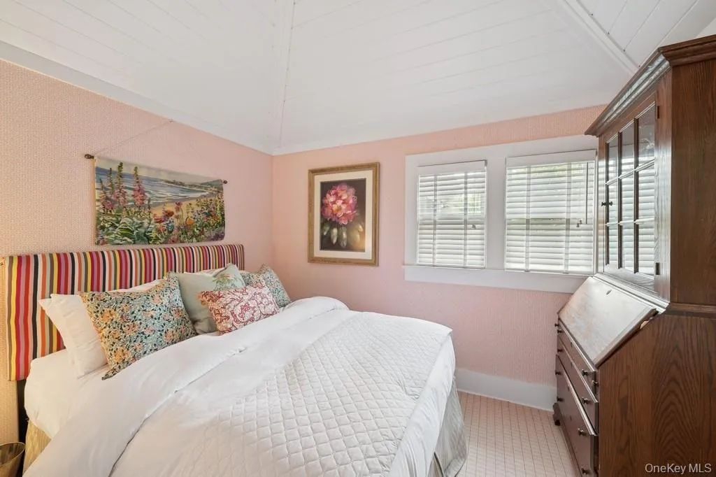 Carpeted bedroom featuring lofted ceiling and baseboards Carpeted bedroom featuring lofted ceiling and baseboards