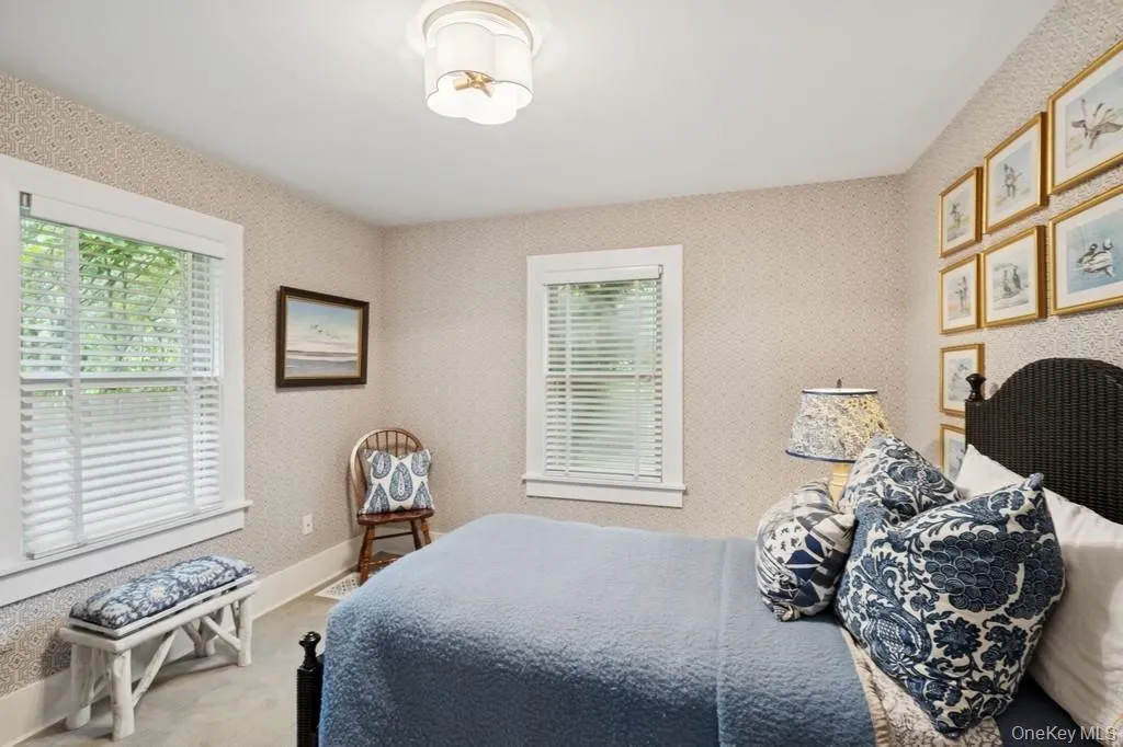 Bedroom with carpet floors and wallpapered walls Bedroom with carpet floors and wallpapered walls