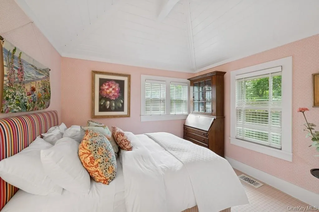 Bedroom with vaulted ceiling and baseboards Bedroom with vaulted ceiling and baseboards