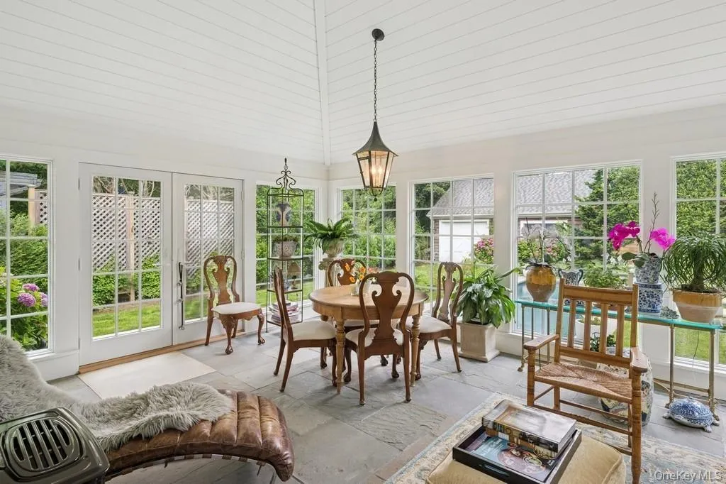 4 seasons Sunroom with healthy amount of natural light and french doors 4 seasons Sunroom with healthy amount of natural light and french doors