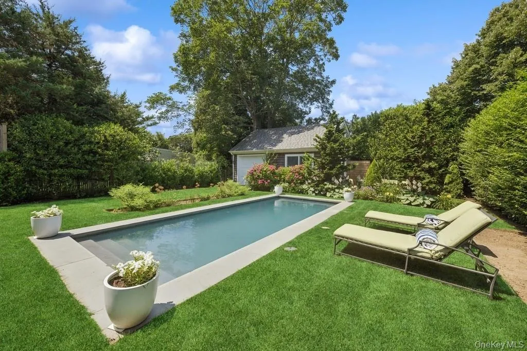 View of swimming pool featuring a yard and an outdoor structure View of swimming pool featuring a yard and an outdoor structure