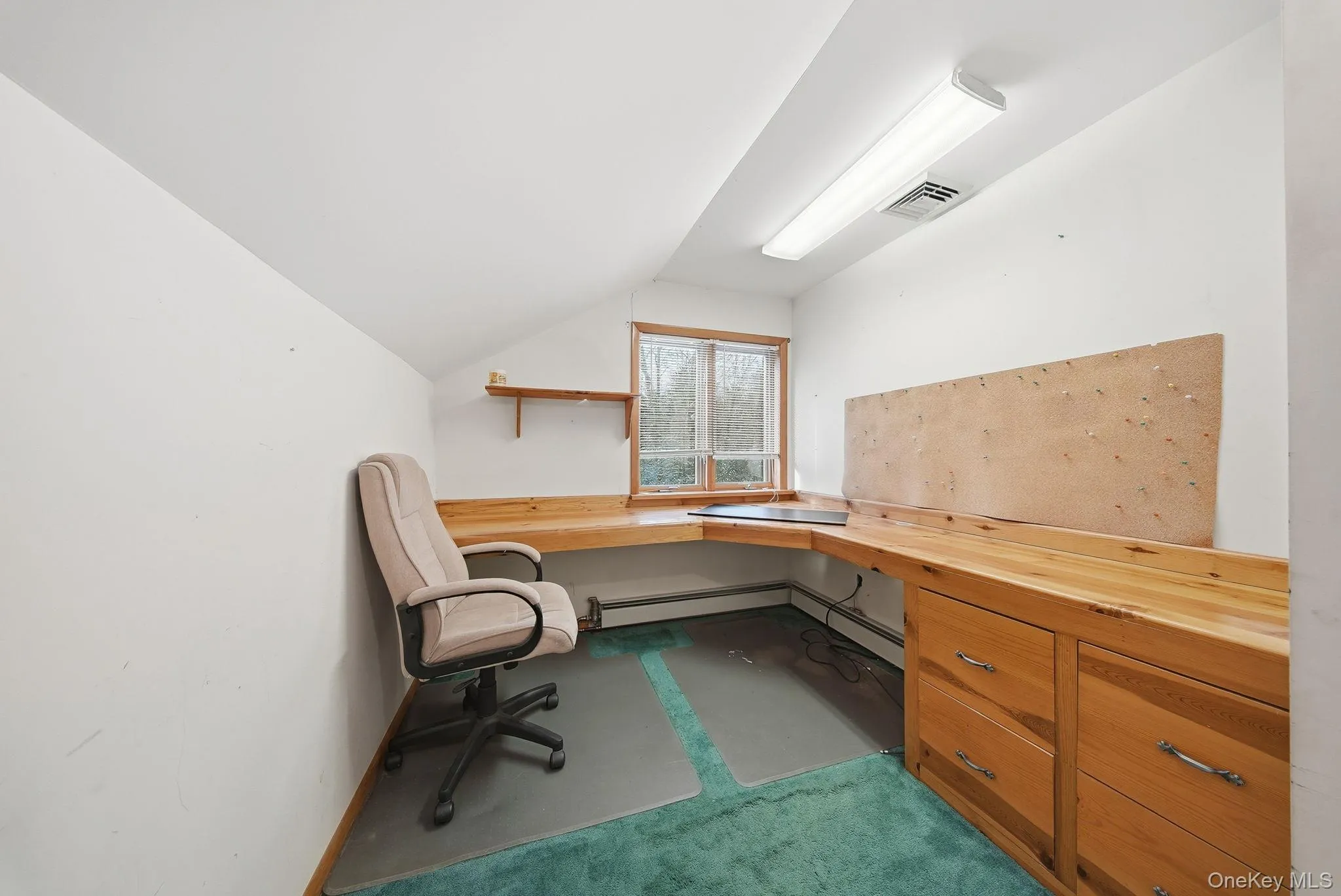 Home office with carpet, vaulted ceiling, built in desk Home office with carpet, vaulted ceiling, built in desk