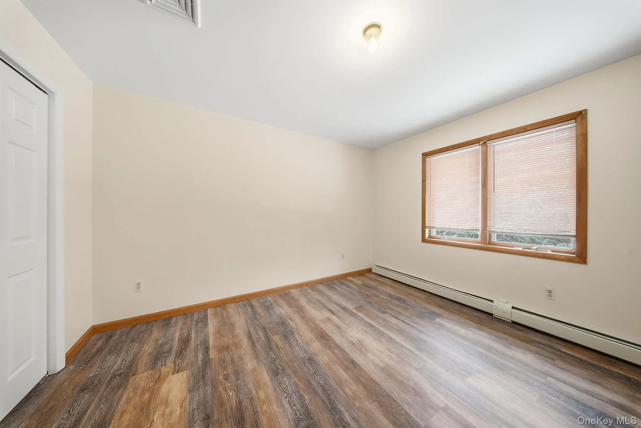 Lower level with a walk out & wood finished floors Lower level with a walk out & wood finished floors