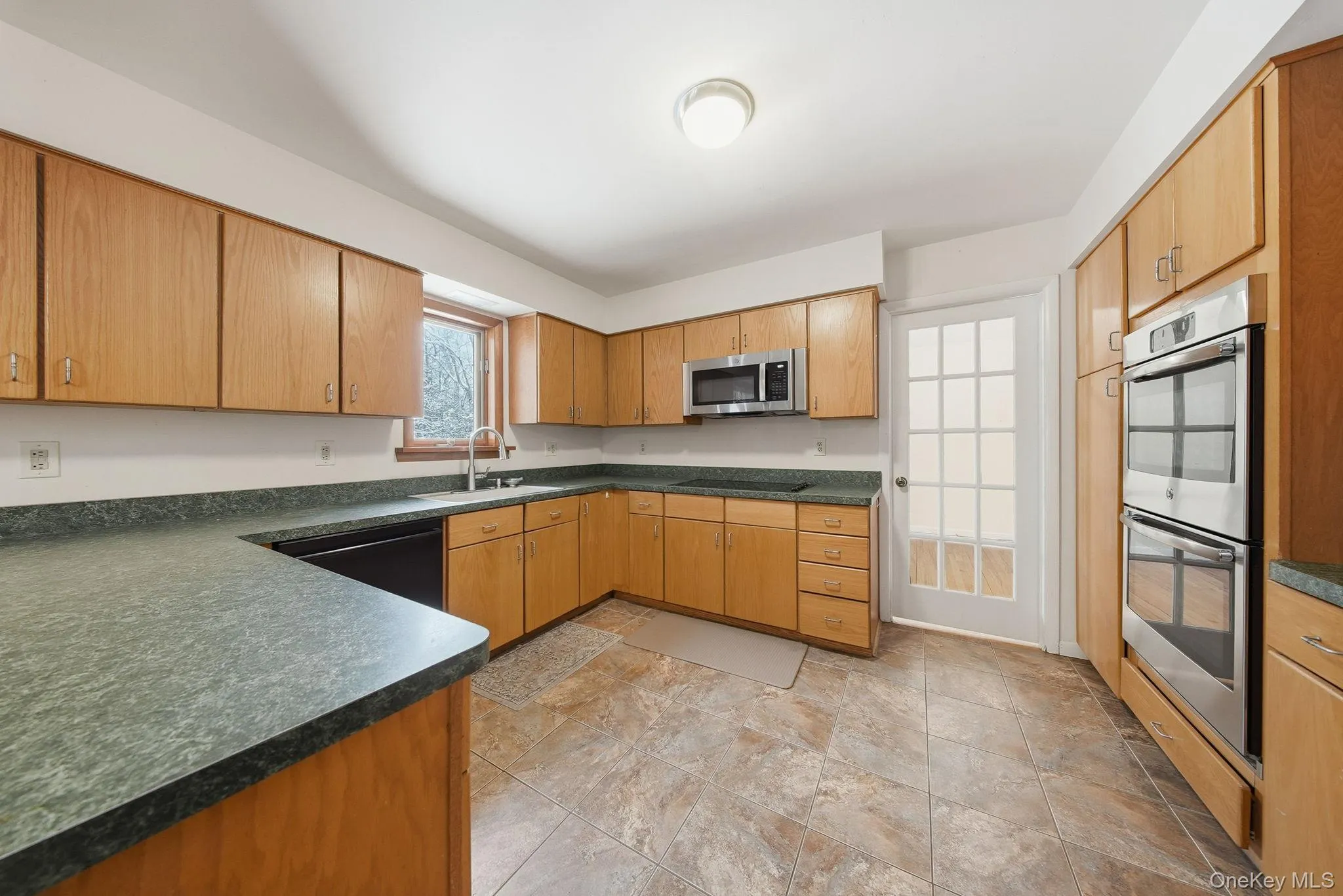 Kitchen with dark countertops, black appliances Kitchen with dark countertops, black appliances