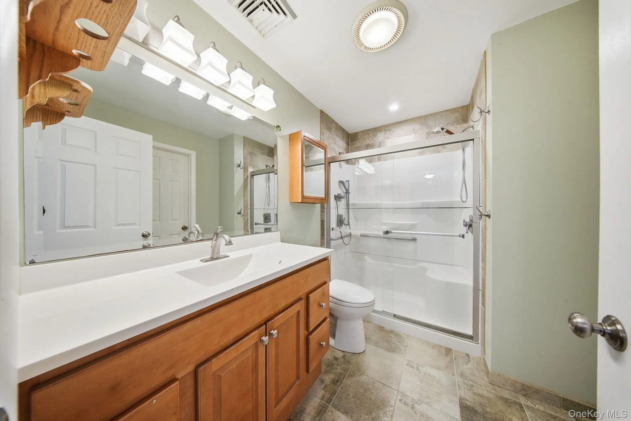 Full bath with vanity and a shower Full bath with vanity and a shower