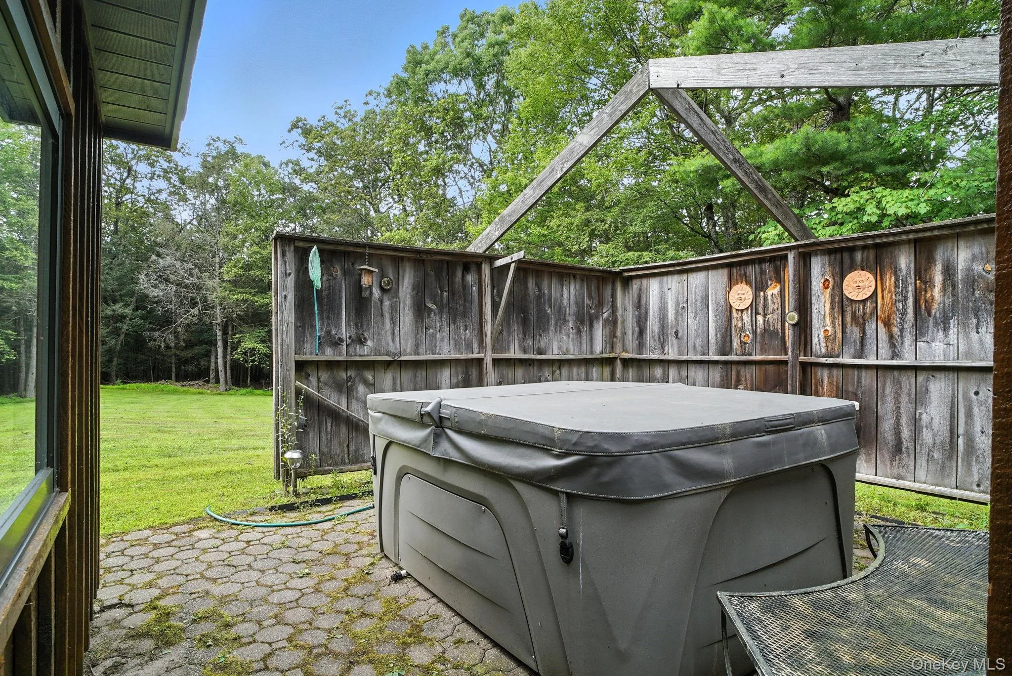 View of patio / terrace featuring a hot tub View of patio / terrace featuring a hot tub