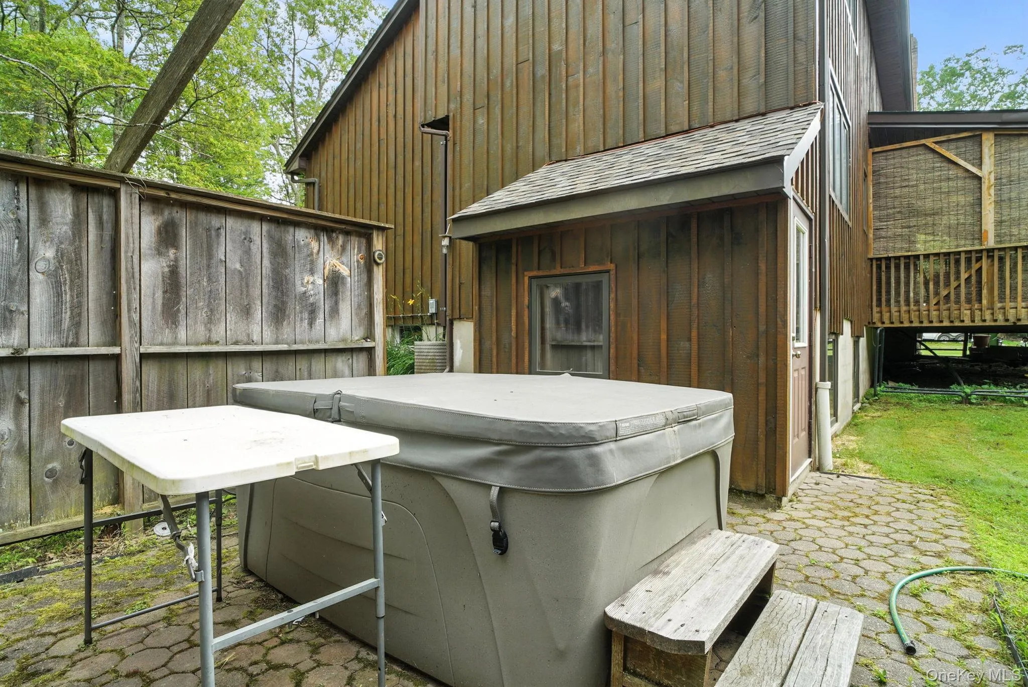 View of patio featuring a hot tub View of patio featuring a hot tub