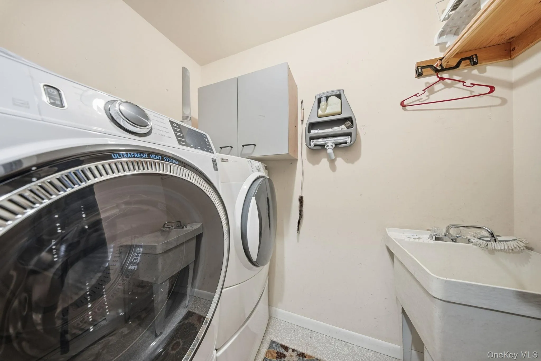 Laundry room with baseboards and cabinet space and c entral vacuum Laundry room with baseboards and cabinet space and c entral vacuum
