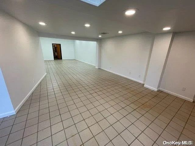 Empty room with light tile patterned floors and recessed lighting Empty room with light tile patterned floors and recessed lighting
