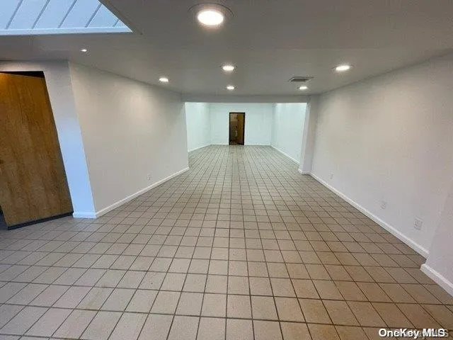 Empty room featuring recessed lighting and light tile patterned floors Empty room featuring recessed lighting and light tile patterned floors