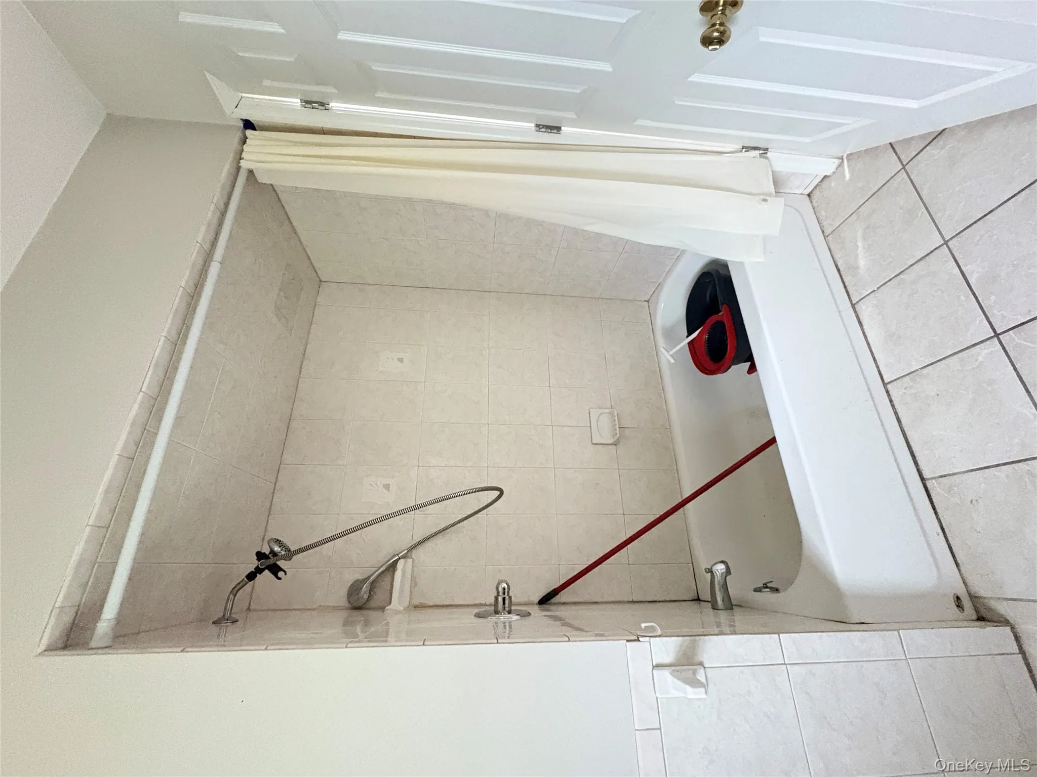 Bathroom featuring shower / tub combo and tile patterned floors Bathroom featuring shower / tub combo and tile patterned floors