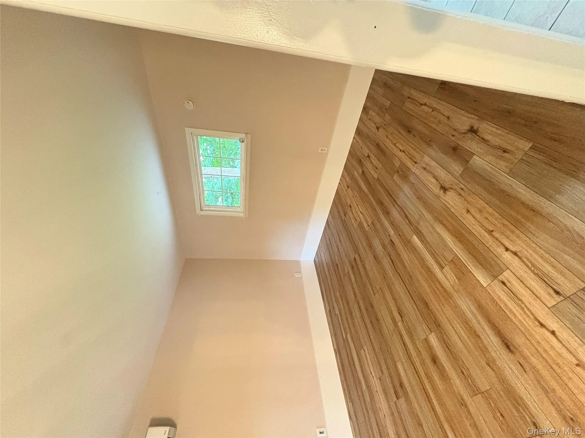 Spare room featuring wood finished floors and baseboards Spare room featuring wood finished floors and baseboards