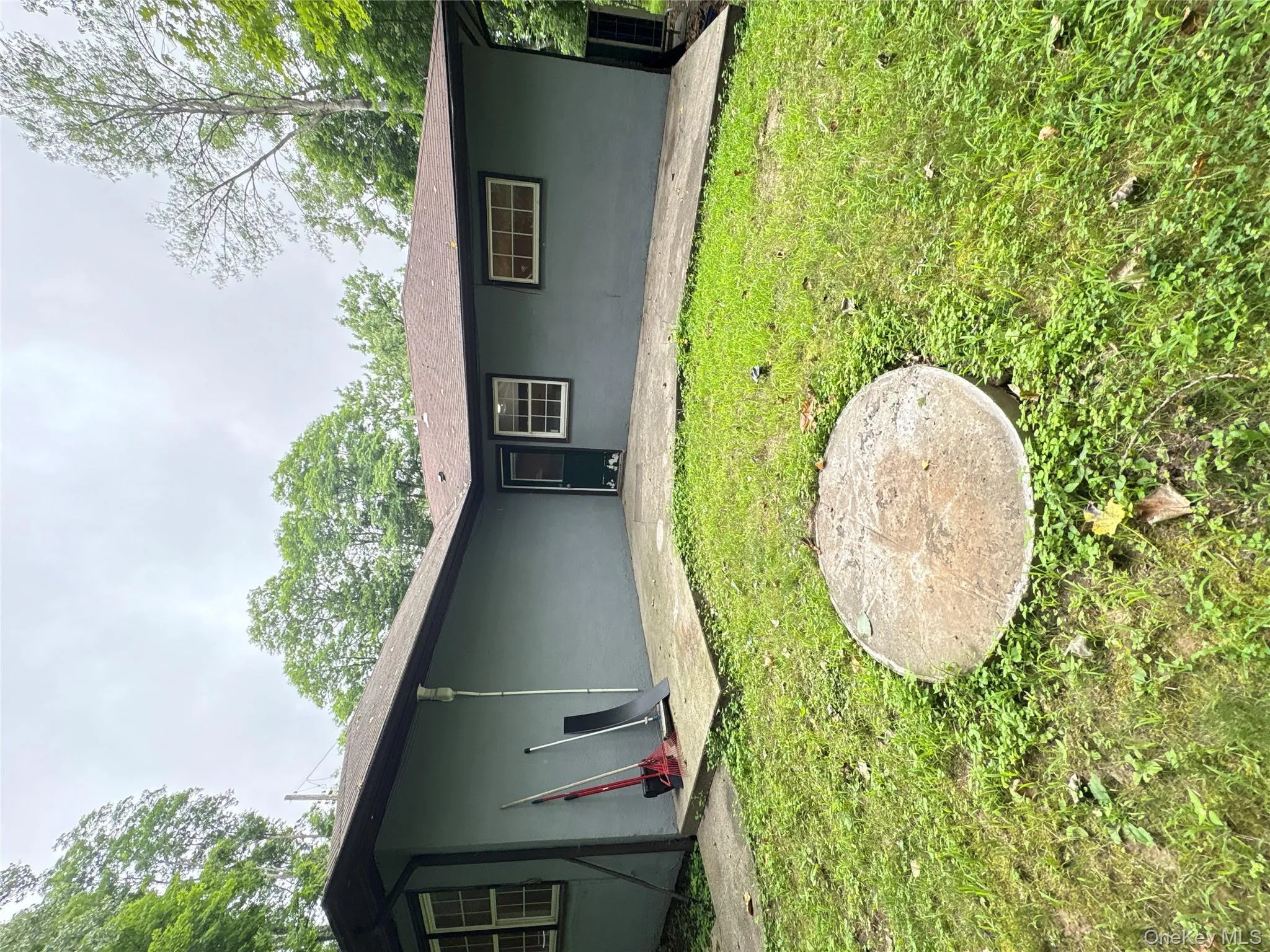 Rear view of property featuring a lawn and stucco siding Rear view of property featuring a lawn and stucco siding