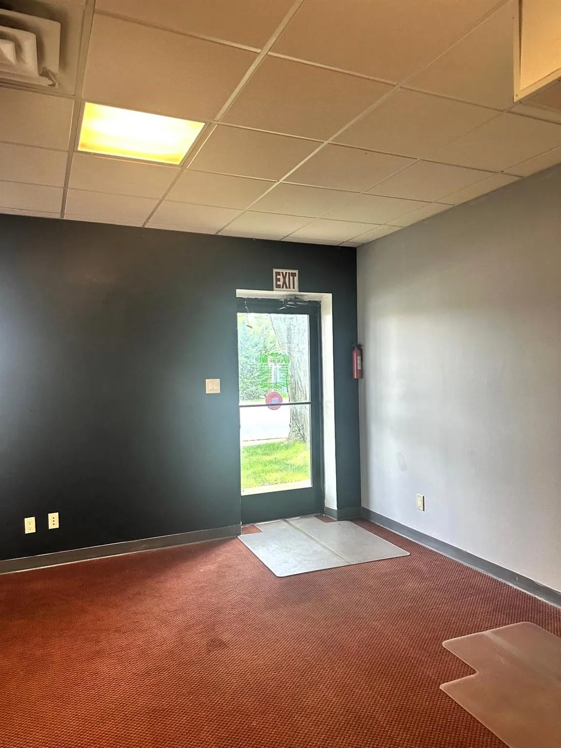 Carpeted spare room featuring a drop ceiling Carpeted spare room featuring a drop ceiling