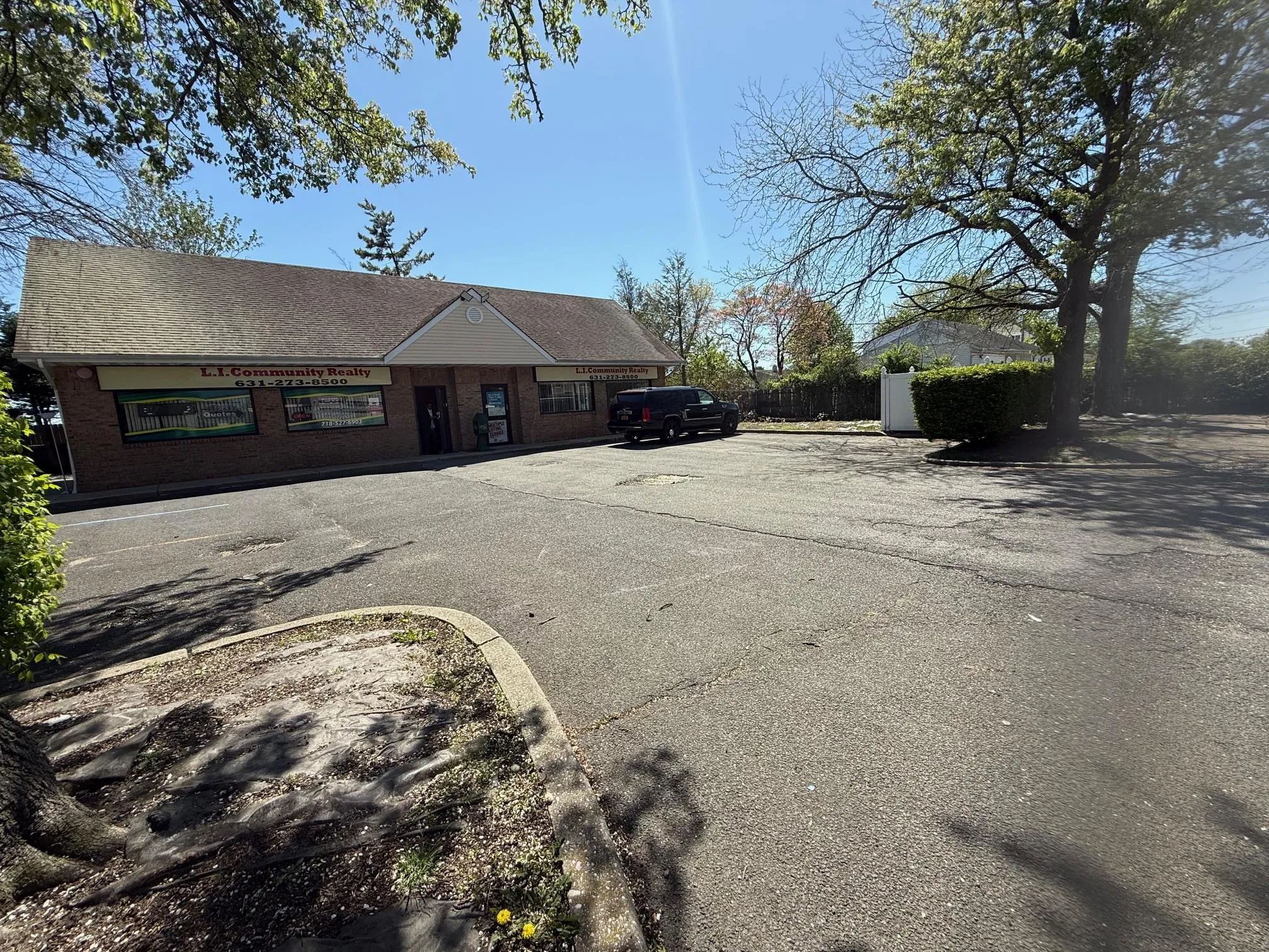 View of front of home featuring brick siding and uncovered parking View of front of home featuring brick siding and uncovered parking