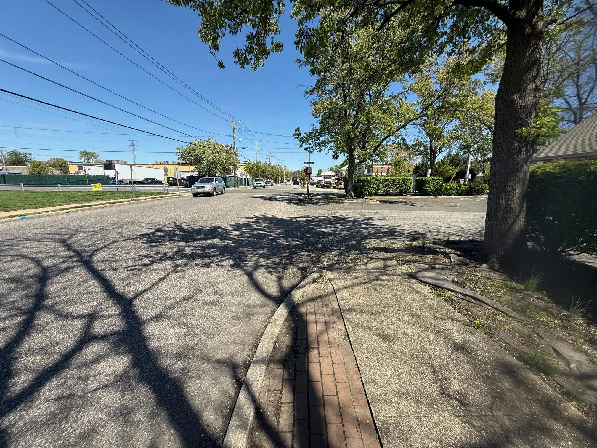 View of asphalt street featuring curbs and sidewalks View of asphalt street featuring curbs and sidewalks