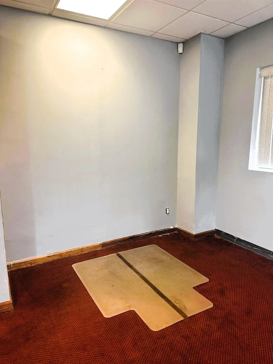 Unfurnished room with carpet flooring and a paneled ceiling Unfurnished room with carpet flooring and a paneled ceiling