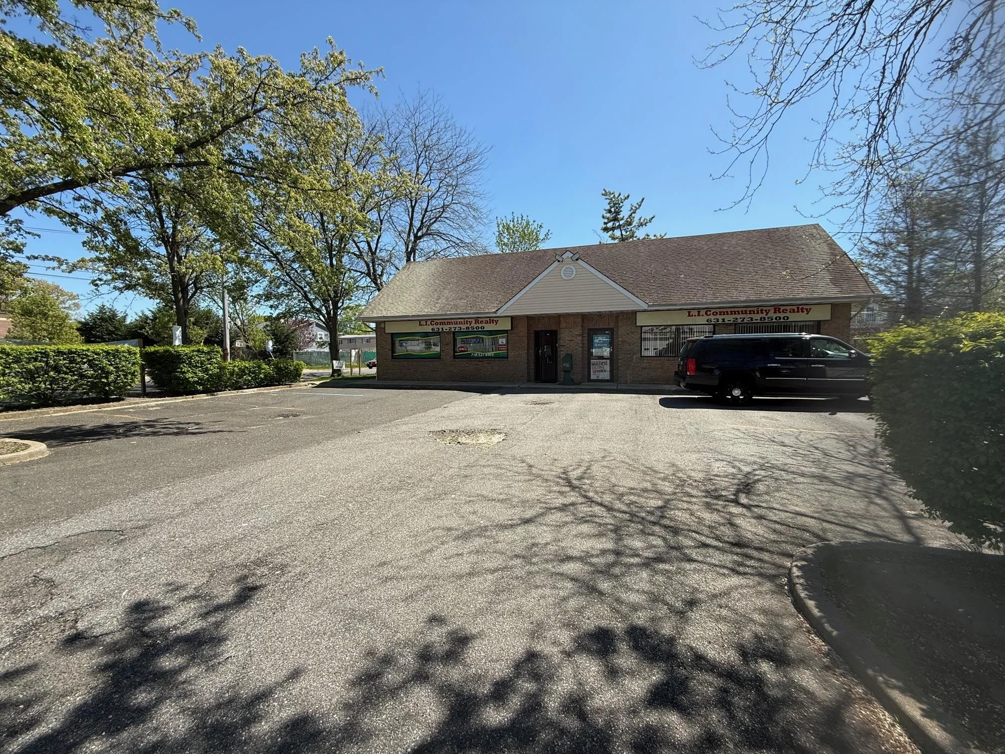 View of front of house featuring brick siding, roof with shingles, and driveway View of front of house featuring brick siding, roof with shingles, and driveway