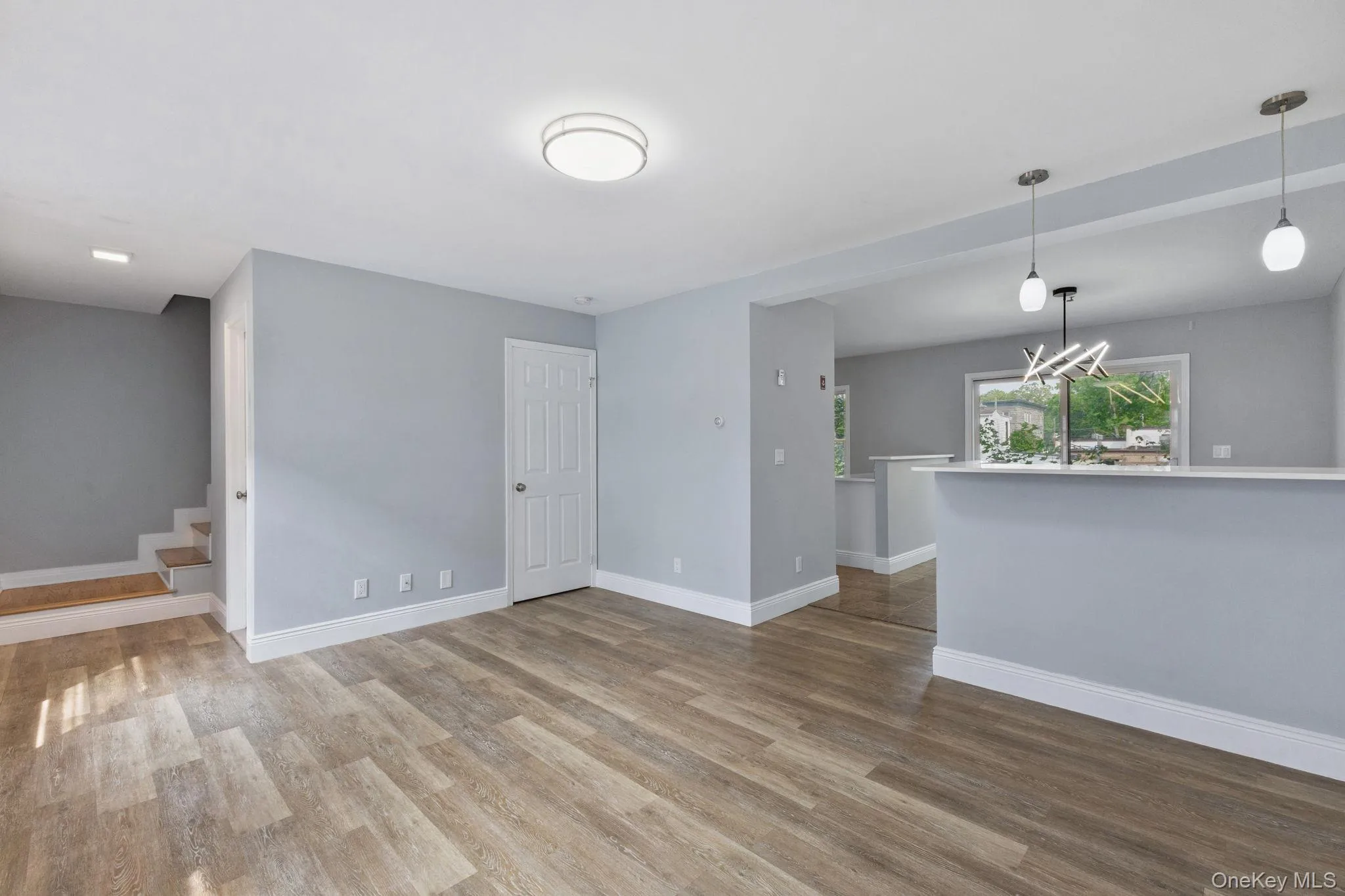 Unfurnished living room with wood finished floors and stairs Unfurnished living room with wood finished floors and stairs