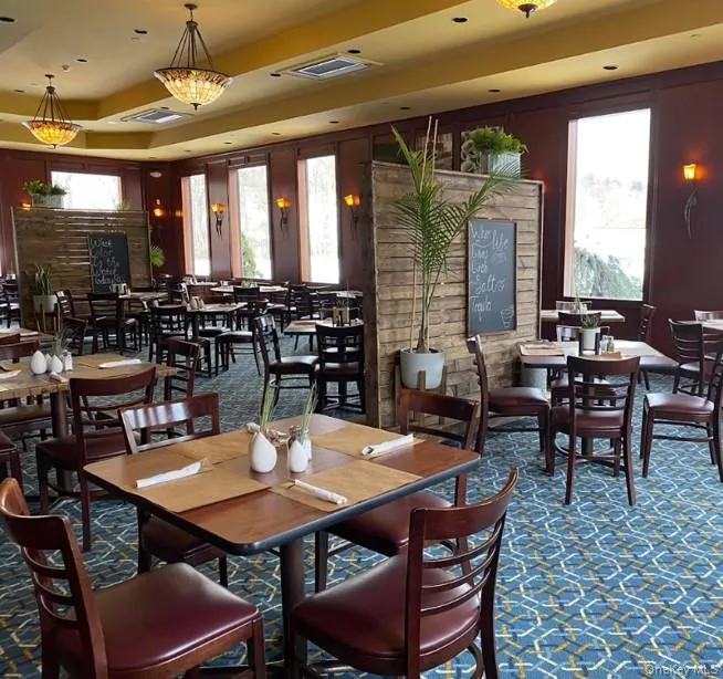 Carpeted dining room featuring healthy amount of natural light and a raised ceiling Carpeted dining room featuring healthy amount of natural light and a raised ceiling