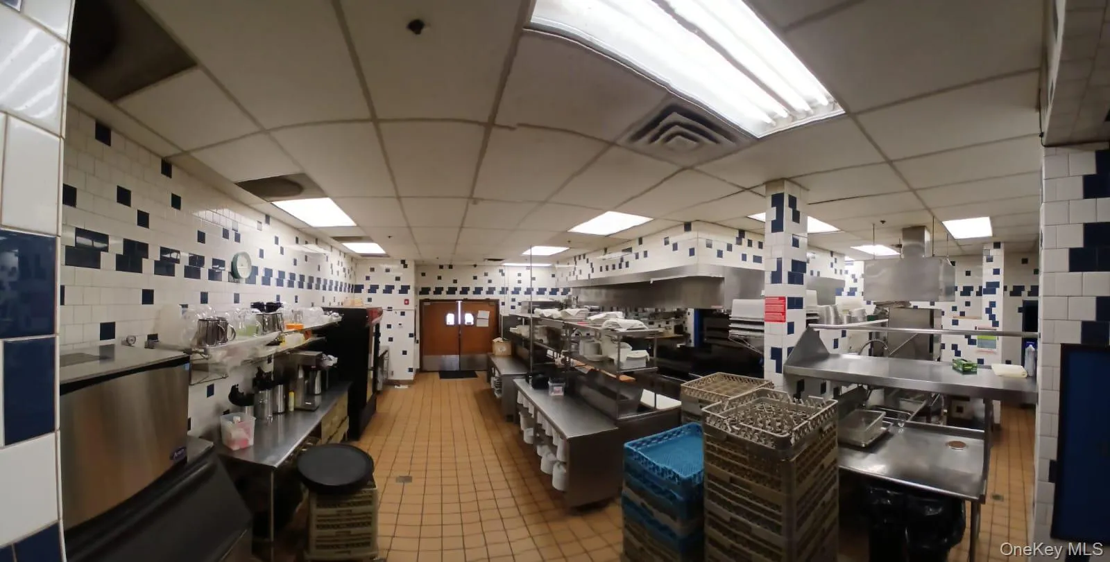 Miscellaneous room with a drop ceiling and tile patterned flooring Miscellaneous room with a drop ceiling and tile patterned flooring