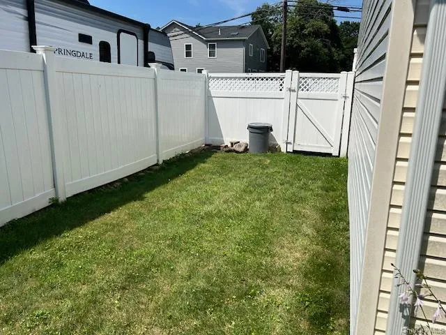 Fenced backyard featuring a gate Fenced backyard featuring a gate