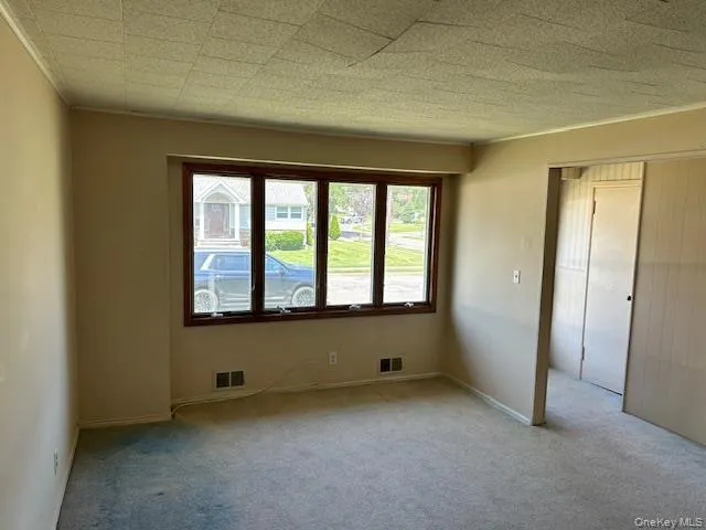 Carpeted spare room with baseboards Carpeted spare room with baseboards