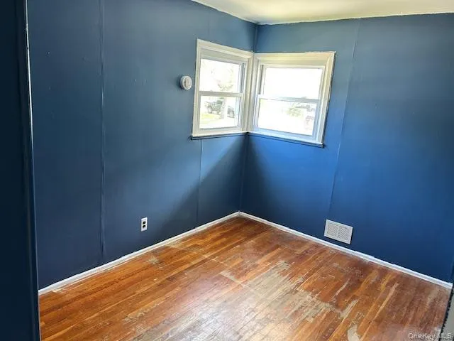 Spare room with wood-type flooring Spare room with wood-type flooring