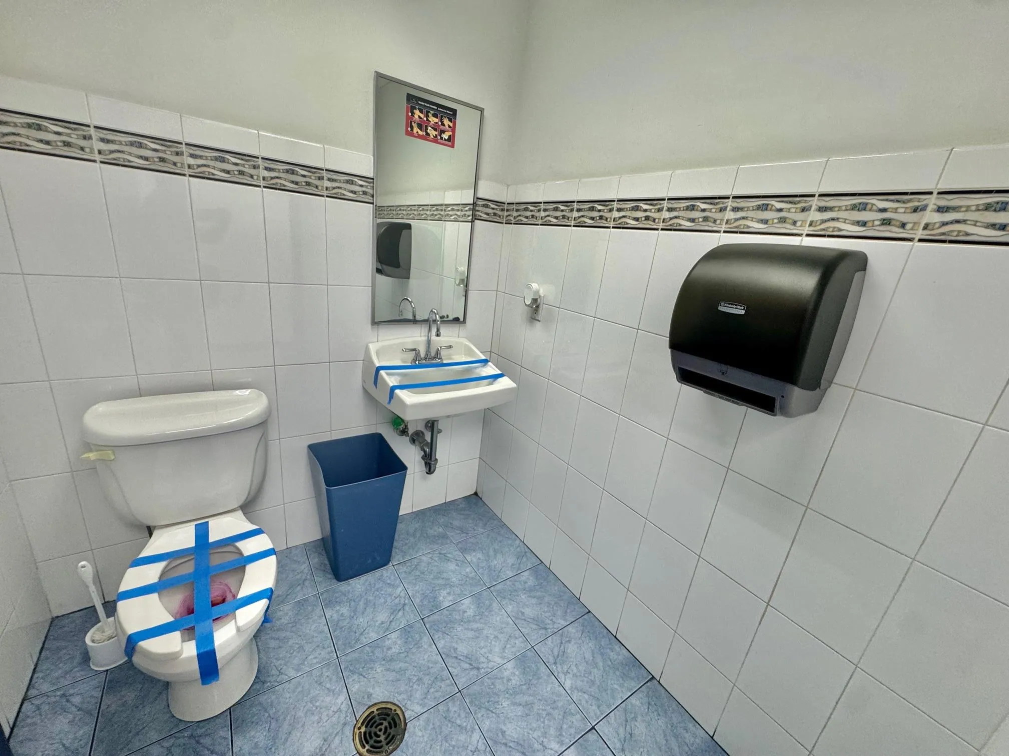 Half bathroom with tile walls and tile patterned floors Half bathroom with tile walls and tile patterned floors