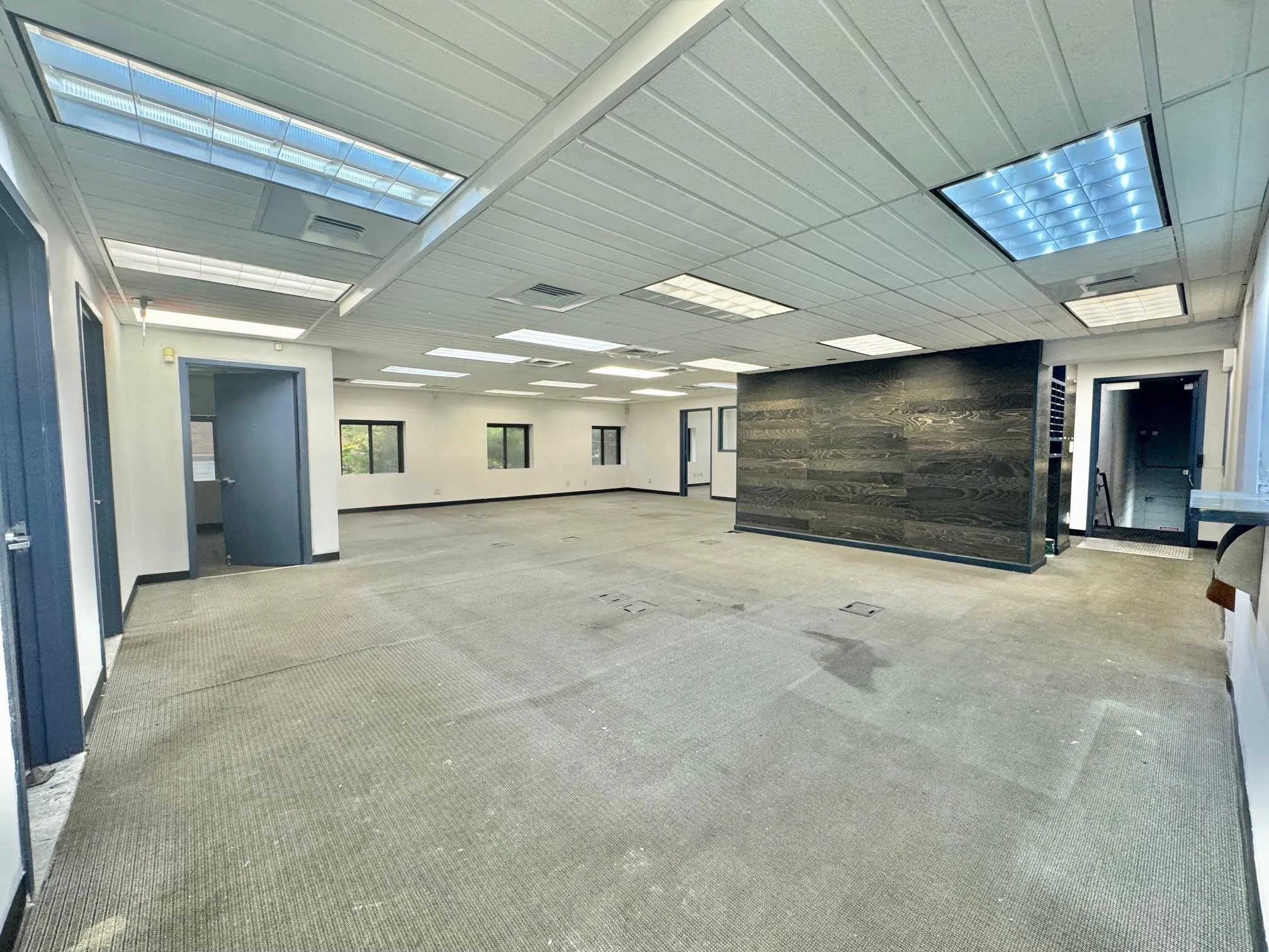 Carpeted empty room with baseboards Carpeted empty room with baseboards