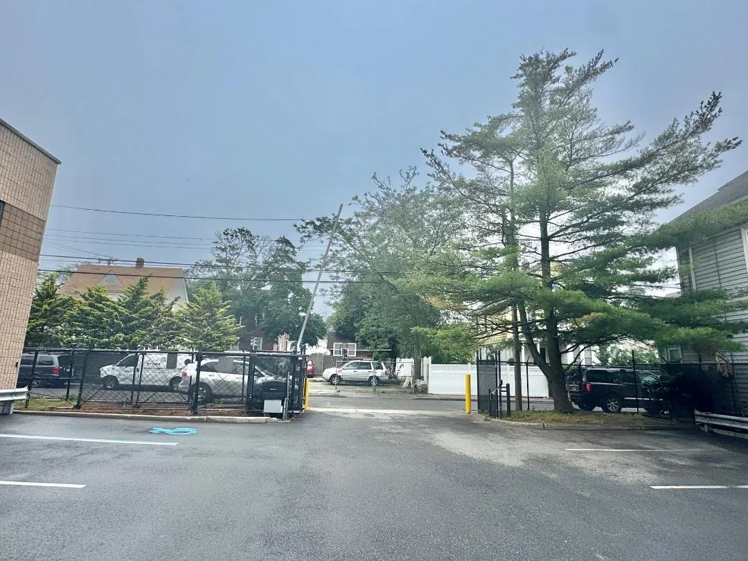 View of asphalt street featuring curbs and a gated entry View of asphalt street featuring curbs and a gated entry