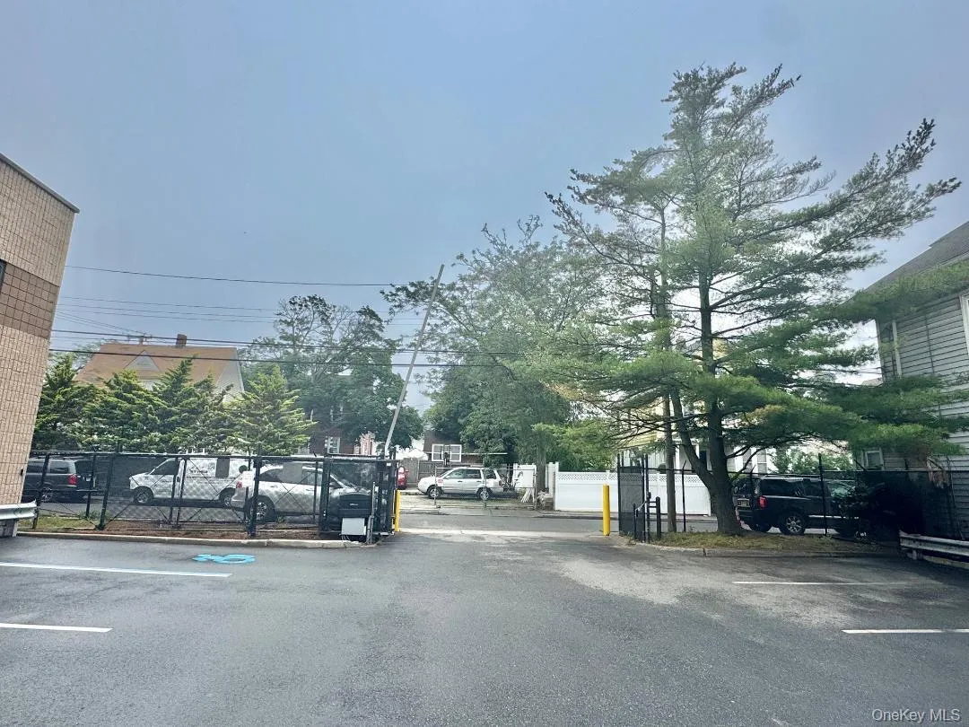View of asphalt street featuring curbs and a gated entry View of asphalt street featuring curbs and a gated entry