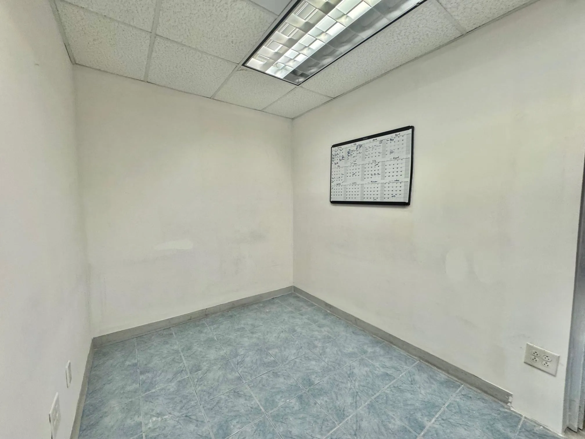 Spare room featuring a drop ceiling and baseboards Spare room featuring a drop ceiling and baseboards