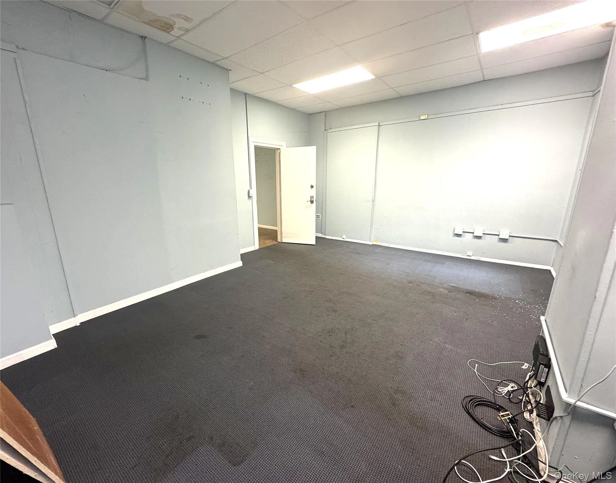 Carpeted spare room with a paneled ceiling Carpeted spare room with a paneled ceiling