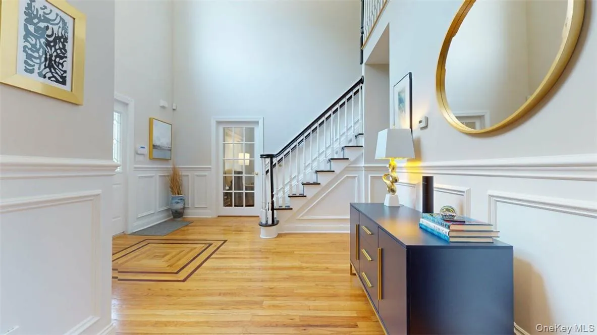 Entryway with a towering ceiling and light hardwood / wood-style floors Entryway with a towering ceiling and light hardwood / wood-style floors