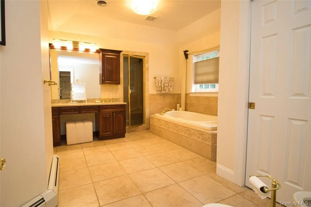 Tray ceiling in extremely spacious Primary Bathroom with marble floors, dual-vanities ,large Carreras marble tiled walk-in shower, Jacuzzi tub, new granite counter, new sinks, new faucets, new top-of-the-line light fixtures, new towel rods, big walk-in storage closet with tons of shelving Tray ceiling in extremely spacious Primary Bathroom with marble floors, dual-vanities ,large Carreras marble tiled walk-in shower, Jacuzzi tub, new granite counter, new sinks, new faucets, new top-of-the-line light fixtures, new towel rods, big walk-in storage closet with tons of shelving